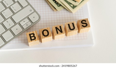 The stock image features wooden blocks spelling BONUS on a white table, with a white keyboard and currency in the backdrop, evoking a professional and lucrative ambiance.