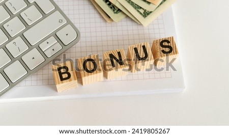 The stock image features wooden blocks spelling BONUS on a white table, with a white keyboard and currency in the backdrop, evoking a professional and lucrative ambiance.