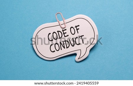 A stock image featuring a whiteboard with the words Code of Conduct written prominently in bold black marker against a vibrant blue background, symbolizing professional standards and ethics.