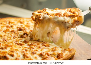 Stock image of Very cheesy pizza slice .Pizza is a savory dish of Italian origin, consisting of a usually round, flattened base of leavened wheat-based dough topped - Powered by Shutterstock