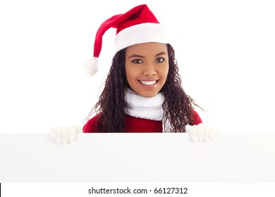 Stock image of woman wearing santa hat holding blank board with copy space - Powered by Shutterstock