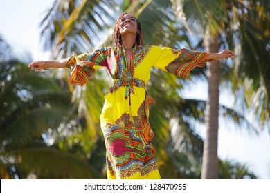 Stock image of a young African American woman outstretching her arms