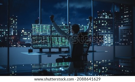 Stock Market Broker Working on a Computer with Multi-Monitor Workstation with Real-Time Investment, Commodities and Foreign Exchange Charts. Successful Businessman Punches Air for Winning a Trade.