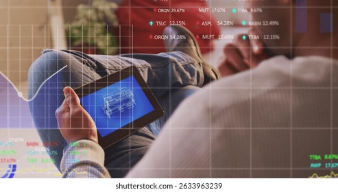 Stock market data processing against mid section of man using digital tablet. Global economy and business technology concept