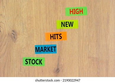 Stock market hits new high symbol. Concept words Stock market hits new high on color papers on a beautiful wooden background. Business and stock market hits new high concept. Copy space. - Shutterstock ID 2190022947
