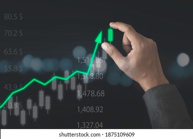 Stock market investment and business growth concept , Businessman holding candle chart of stock market investment with increase green arrow.