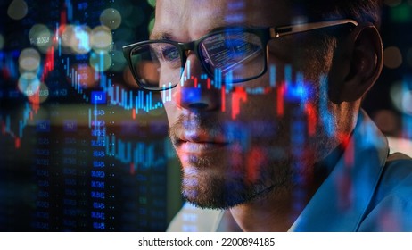 Stock Market Trader Working Investment Charts, Graphs, Ticker, Diagrams Projected on His Face and Reflecting in Glasses. Financial Analyst and Digital Businessman Selling Shorts and Buying Longs - Shutterstock ID 2200894185