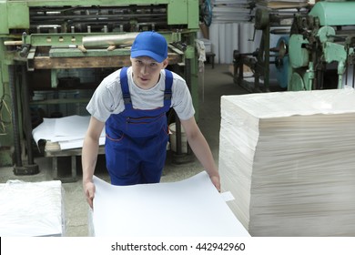 Stock Offset Paper.  Young Man In Cap Working In Print Factory