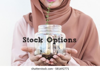 Stock Options : Words typed. Conceptual image focus on women investment, business, finance and financial planning with blur image of women holding a glass jar with coins inside and growing small tree.