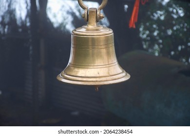 Stock photo of  ancient copper or bronze bell hanging on a iron frame at Hindu temple on blur foggy background. Picture captured at sateri hill station Kolhapur ,Maharashtra, India. - Shutterstock ID 2064238454