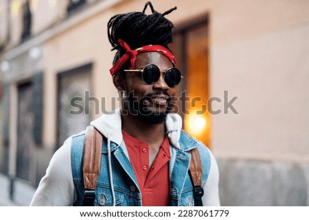 Stock photo of attractive and young african american boy wearing sunglasses.