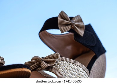 Stock photo of beautiful pair of black and cream color high heel sandals displayed on blur background,kept on table under bright sunlight at Bangalore city Karnataka India.