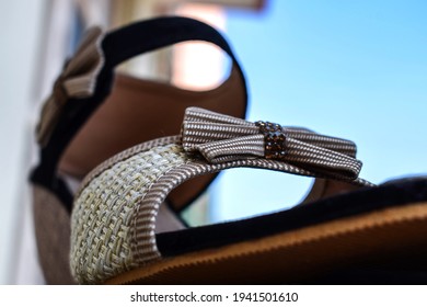 Stock photo of beautiful pair of black and cream color high heel sandals displayed on blur background ,kept on table under bright sunlight at Bangalore city Karnataka India.