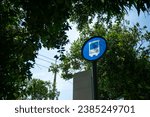 A stock photo of a bus stop typically features an image of a bus stop or bus shelter, which is a designated place where people can wait for a public bus to arrive.