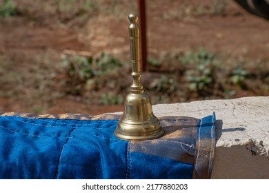 Stock photo of carved designer copper or bronze bell or hand bell used for worshiping god in hindu temples. bell kept on wall under bright sunlight at Kolhapur, Maharashtra, India. focus on object. - Powered by Shutterstock