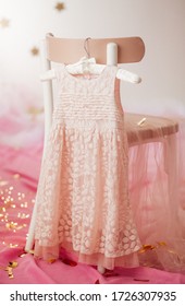 Stock Photo - Child dress on hanger on pink background - Shutterstock ID 1726307935