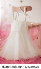Stock Photo - Child dress on hanger on pink background - Shutterstock ID 1727360923