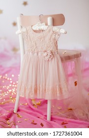 Stock Photo - Child dress on hanger on pink background - Shutterstock ID 1727361004