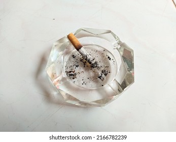 stock photo of a cigarette on a glass ashtray