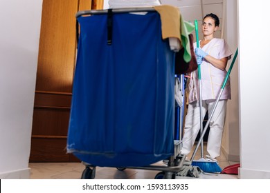 Stock Photo Of A Cleaning Trolley And A Hotel Cleaner Next Door With A Broom In Hand. Lifestyle