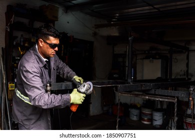 Stock photo of concentrated man wearing special gloves working in blacksmith shop. - Powered by Shutterstock