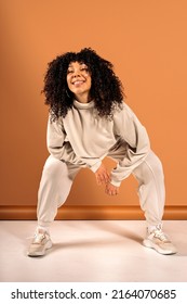 Stock photo of cool african american dancer posing in studio shot against brown background. - Shutterstock ID 2164070685