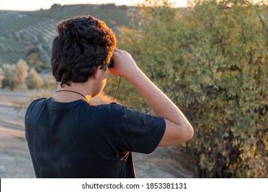 Stock Photo Of Faceless Boy Using Binoculars In The Countryside For Birdwatching.