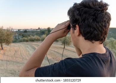 Stock Photo Of Faceless Boy Using Binoculars In The Countryside For Birdwatching.