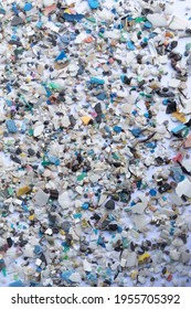 Stock photo of microplastics scattered on a white surface.