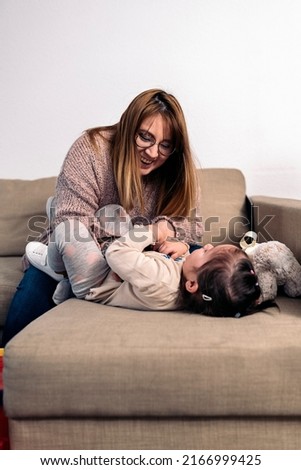 Similar – Newborn baby girl sleeping lying on blanket with her mother