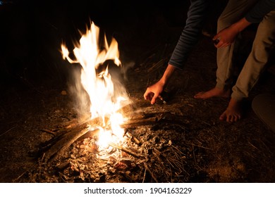 Stock Photo Of Unrecognized Person Stoking The Fire In The Forest.