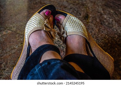 Stock photo of women feet, wearing black and cream color fancy high hell sandal and posing for photo. Picture captured under natural light at Bangalore, Karnataka, India. focus on object.