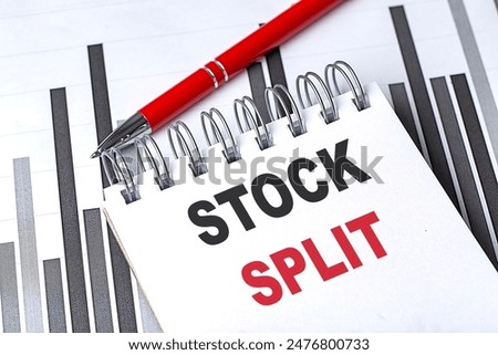 STOCK SPLIT text on a notebook on chart with pen . 