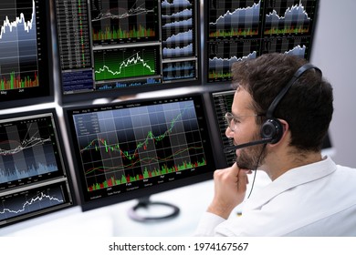 Stock Trader Man Using Multiple Computer Monitors
