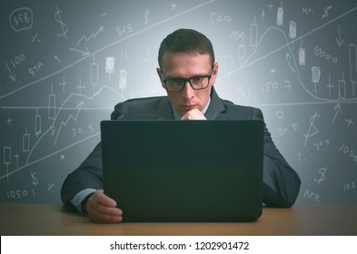 Stock Trader Is Sitting By The Table And Is Working On The Laptop On The Stock Market. Technical Analysis.

