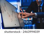 Stock traders pointing highest stock market on dynamic valued analysis on monitor real time screen, cooperating business investment in financial company to plan successful stock exchange. Sellable.