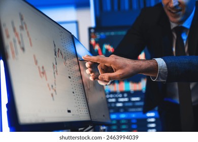 Stock traders pointing highest stock market on dynamic valued analysis on monitor real time screen, cooperating business investment in financial company to plan successful stock exchange. Sellable.