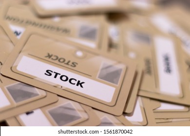 Stock word on a yellow card, shallow depth of field. Multiple cards visible out of focus. Concept of stock photos, stocks