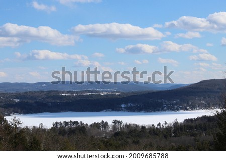 Stockbridge Bowl, also known as Lake Mahkeenac, in Massachusetts in winter with snow on the ground seen from a viewpoint known as "Olivia's Overlook"