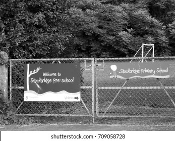 Stockbridge, Hampshire England - June 19, 2017: Monochrome Welcome To Stockbridge Pre School Banner Mounted On Gate To Playing Field