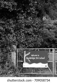 Stockbridge, Hampshire England - June 19, 2017: Monochrome Welcome To Stockbridge Pre School Banner Mounted On Gate To Playing Field