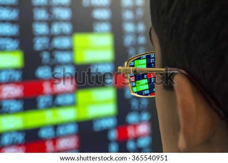 stockbroker at the screen with quotes