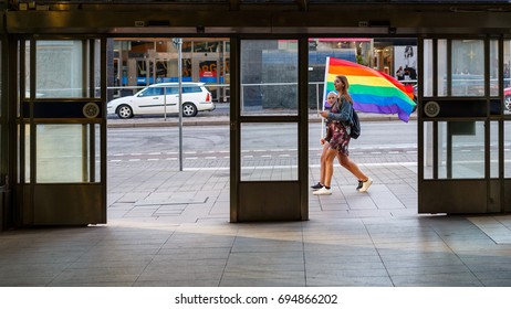 Stockholm August 2017, Two Pride Celebrating Persons Passing The Entrance Of Metro Station Of Hötorget