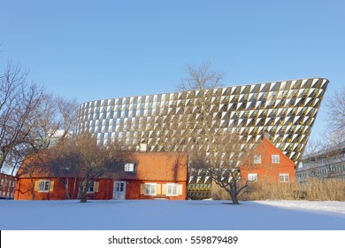 STOCKHOLM - JAN 15, 2017: Spectacular Conference Building Aula Medica At University Hospital Karolinska Institutet. Old Red Cottages And Snow In The Foreground. January 15, 2017 In Stockholm, Sweden