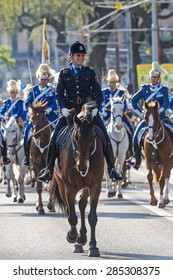 STOCKHOLM - JUN 06, 2015: Happy Police Woman On Her Horse Infront Of The Swedish Royal Guards In Blue Uniforms At The Swedish National Day.