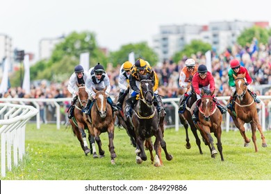 STOCKHOLM - JUNE 6: Action when jockeys and horses coming out from the last curve at the Nationaldags Galoppen at Gardet. June 6, 2015 in Stockholm, Sweden.