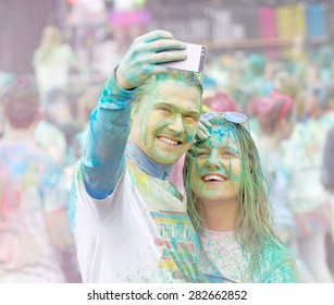 STOCKHOLM - MAY 23, 2015: Good Looking Couple Covered With Color Powder Taking A Selfie During The Public Event The Color Run, May 23, 2015 In Stockholm, Sweden