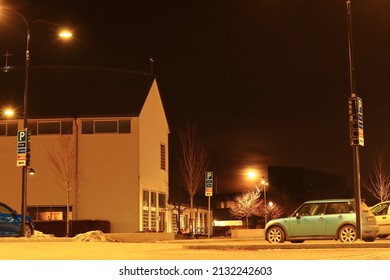 Stockholm, Sweden. 02-19-2022. Full Moon Behind The Clouds. Urban Square Or Parking Lot At The Night.