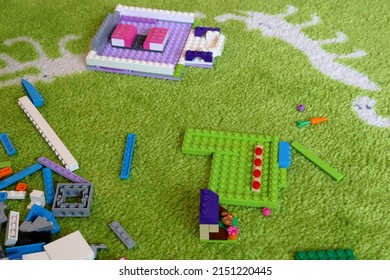 Stockholm, Sweden. 04-02-2022. Lego Pieces At A Green Carpet. Small Building Construction. Fun For The Whole Family.