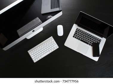  STOCKHOLM, SWEDEN - 15 October 2017: IMac Computer, Mac Book, IPhone, Keyboard And  Mouse On Black Table, Created By Apple Inc.